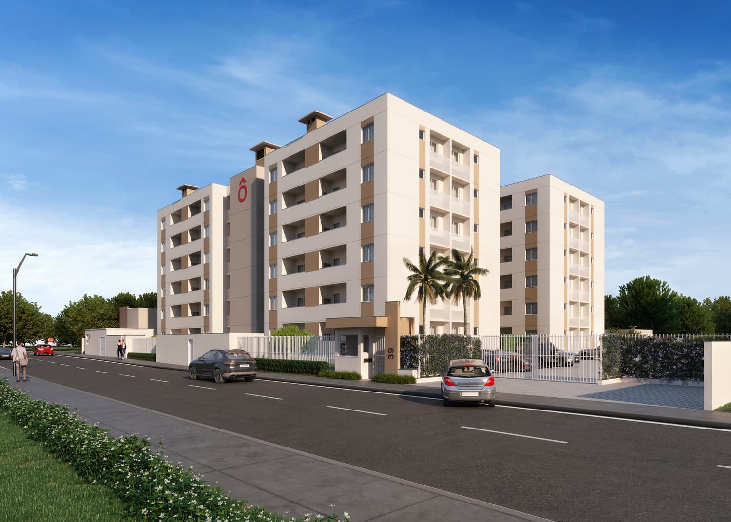 Fachada externa de edifício residencial com tons claros, varandas e portaria de acesso.
